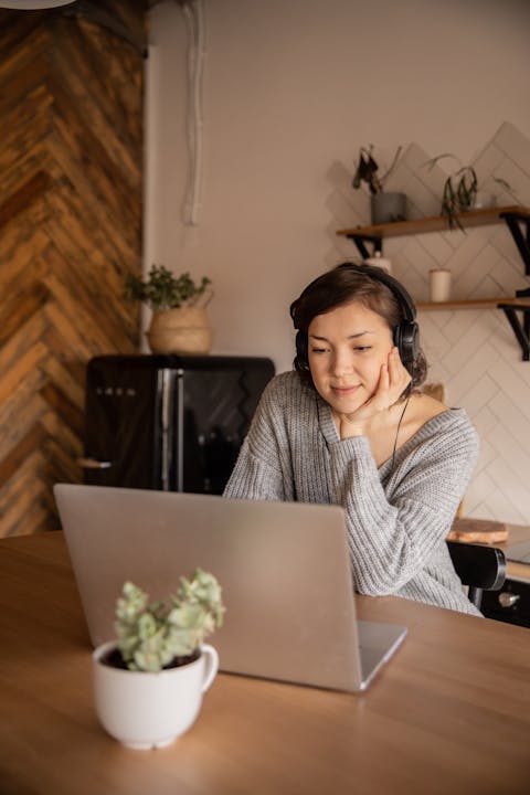 young-woman-using-laptop-in-kitchen