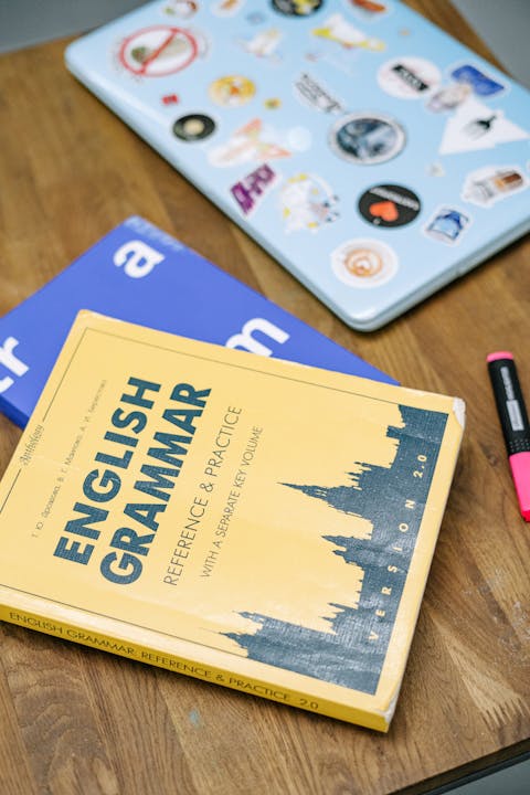 laptop-and-books-on-brown-wooden-table